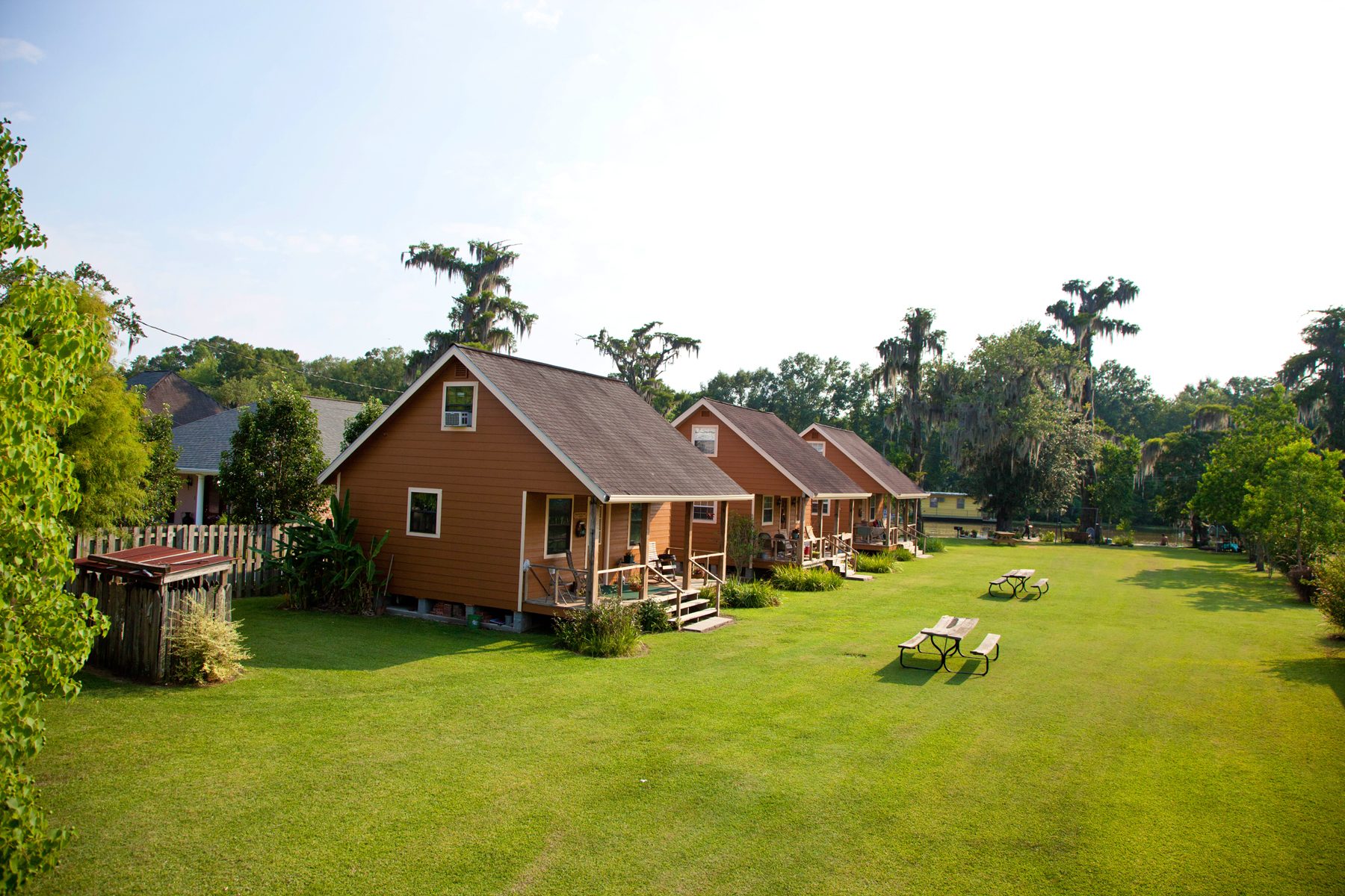 The cabins in a row across the grassy lawn
