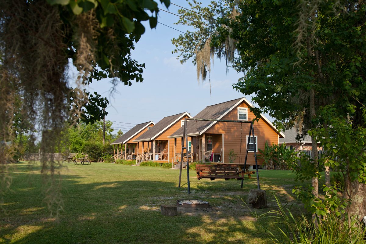 The cabins seen under the oak trees