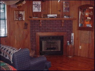 The brick gas-log fireplace in Cabane Danos